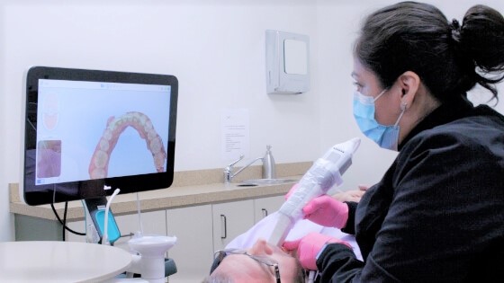 Dental team member capturing images with the iTero five plus scanner