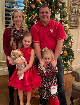Doctor Boone and her family in front of Christmas tree
