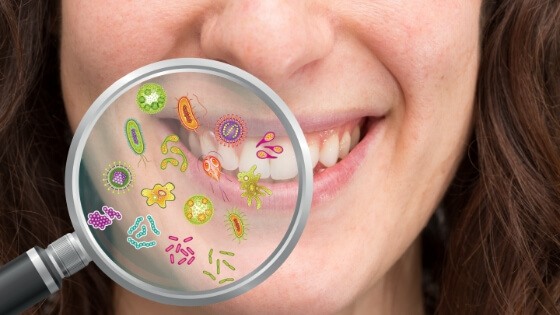 Closeup of smile with animated bacteria representing gum disease therapy