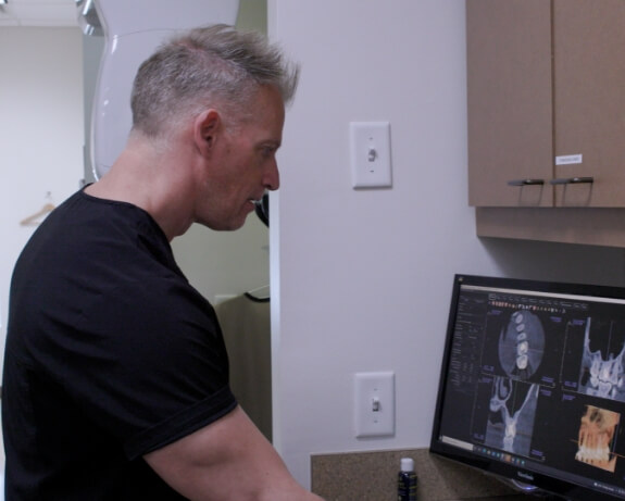 Doctor Devlin looking at digital bite impressions