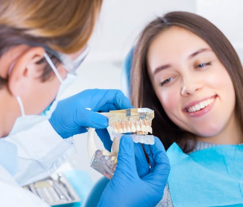 Dentist talking to dental patient during preventive dentistry visit