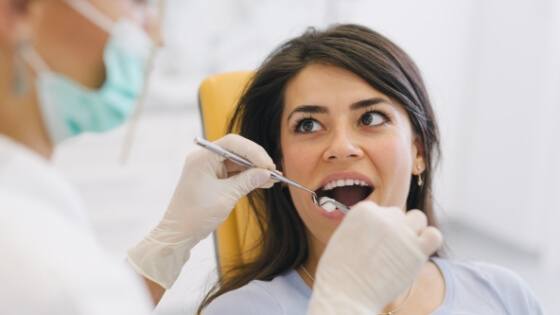 Dental patient receiving an oral cancer screenin