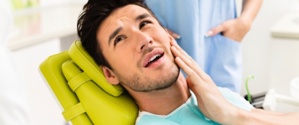 Man with jaw pain before T M J therapy