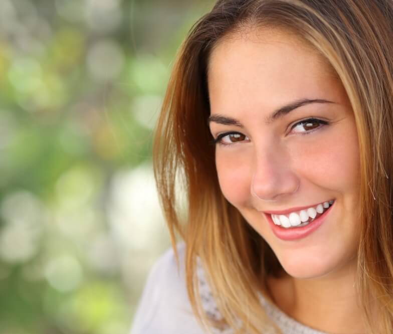 Woman with bright smile after teeth whitening