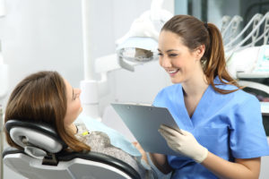 Dentist smiling and talking to patient