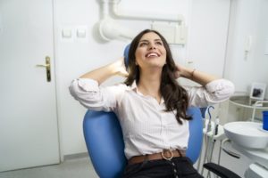 Woman happily relaxing in dentist’s chair.