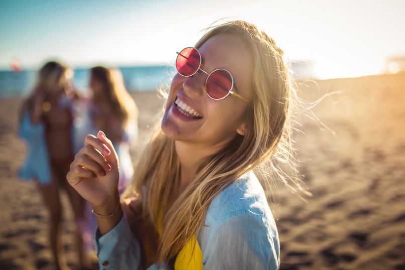 young woman smiling at the beach 