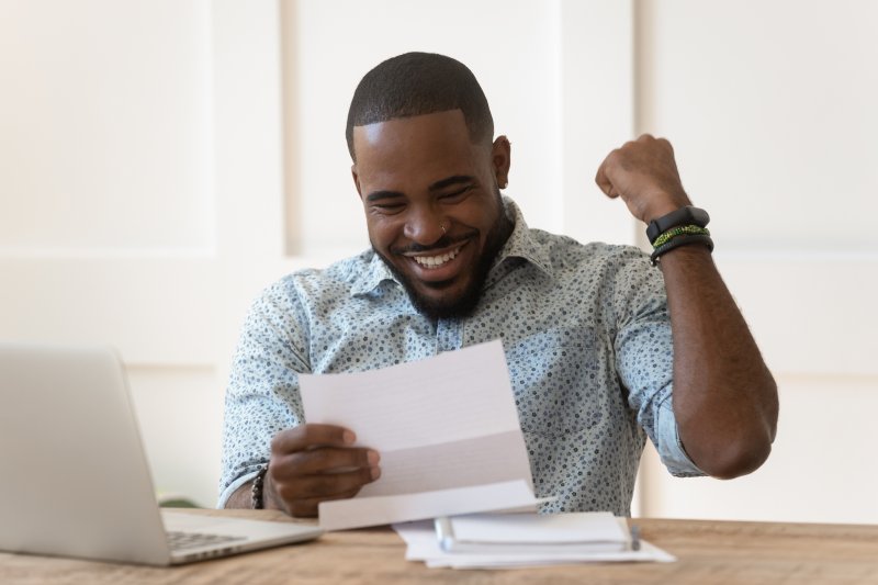 man smiling after getting tax refund 