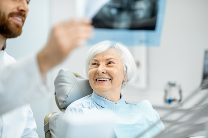 woman smiling while looking at dentist 